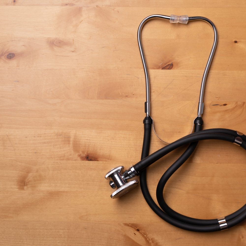 A top view of a stethoscope on a wooden surface
